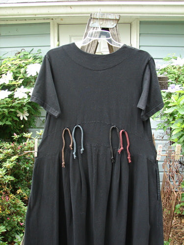 Vintage 2000 LuLu's black dress with ties, featuring a yoked waistline, drop pockets, button closure, wide swingy lower, pleated front darts, leaf theme paint, and loops for rippies. Perfect for creative self-expression.