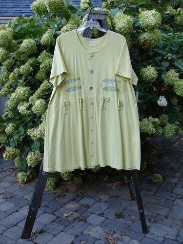 1999 Carry All Dress Double Pike Citron Size 2: A green shirt with fish on it, featuring 8 original blue fish buttons, a scoop neckline, and a centered rear draw cord.