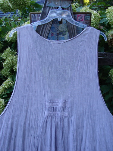 Barclay Gauze Farmer Jen Sleeveless Tunic, Lilac, Size 2. A light cotton dress with a widening A-line shape, deep V neckline, and arm openings. Features a stacked lower pocket ensemble. Length: 37".
