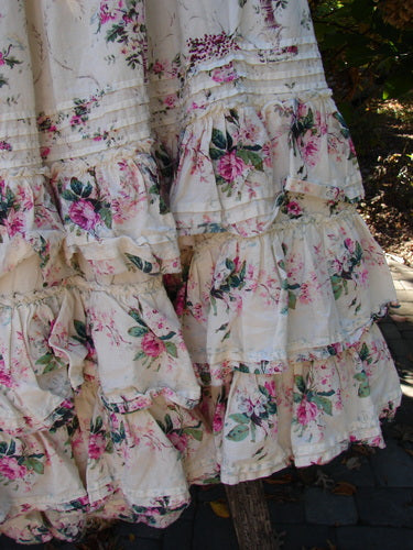 Close-up of Magnolia Pearl Penelope Skirt Des Rosiers Floral Idealist OSFA, showcasing its multi-tiered ruffles and floral print, highlighting craftsmanship with pintucks and lace detailing. Ideal for vintage-inspired fashion enthusiasts.