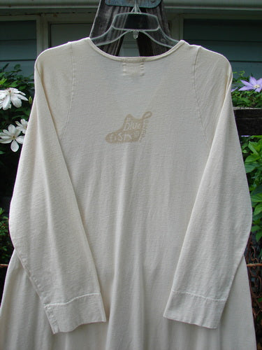 A vintage 2001 T Snap Dress by BlueFishFinder: White shirt with logo, A-line silhouette, offset pockets, signature Blue Fish stamp, V neckline. Organic cotton, game piece theme. Size 1, 40 bust.