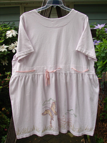 Vintage 1999 Ribbon Dress Butterfly Orchid Size 2 hanging on a clothesline. Organic cotton, double paneled neckline and waistline with button holes, replaced ribbon, bell shape, empire waist, butterfly theme paint.