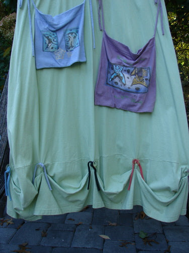 1997 Salt Water Taffy Jumper Sea Life Mellon Size 2 features a pale-green fabric with lavender and pale blue pockets, abstract appliqués, gathered hem ties, and versatile design elements reflecting Blue Fish's creative fashion ethos.