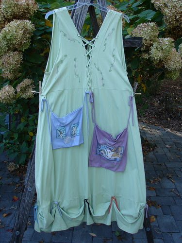 1997 Salt Water Taffy Jumper Sea Life Mellon Size 2, light-green, sleeveless, knee-length with lace-up V-neck, back ties, hem gathers, and pinned pastel pouches, showcasing Blue Fish's creative, vintage style.
