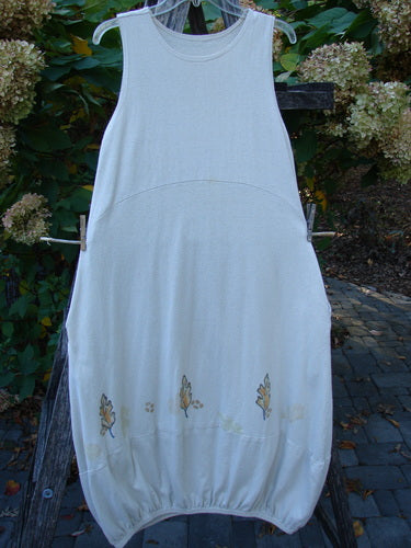 2000 Cotton Hemp Libby Jumper Falling Leaf Dove Altered Size 1 hangs on a clear hanger, featuring a sleeveless design, A-line shape, and autumn-leaf embroidery near its gathered hem.
