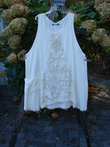 Barclay Slub Figure 8 Lace Pocket Pinafore Dress Soft Floral Crème Size 2 displayed outdoors, featuring a central vine pattern, unique figure-eight seams, pocket detail, and lacy hem on a wooden ladder.