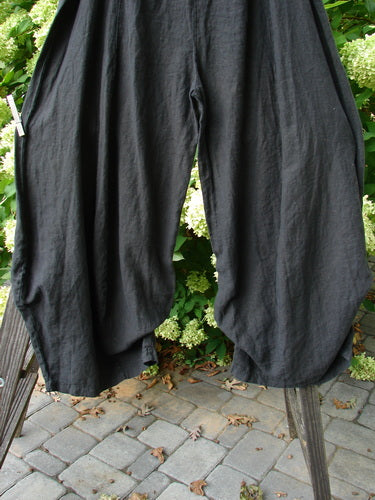 Barclay NWT Billow Pant on wooden stand, mid-weight linen, unique bottom cut, knee-down 3D diamond drape, size 2.