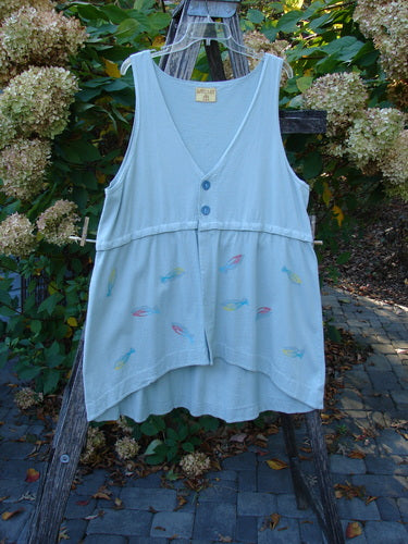 Barclay Little Tree Vest Dragonfly Fish Cucumber Size 1 displayed on an easel, featuring a V-neck, blue buttons, multicolored fish motifs, flared hem, and wooden-edged button front.