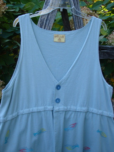Barclay Little Tree Vest Dragonfly Fish Cucumber Size 1 hangs on a wooden fence, showcasing its deep V-neck, empire waist, buttoned bodice, and vibrant fish print, embodying BlueFishFinder's vintage, expressive style.