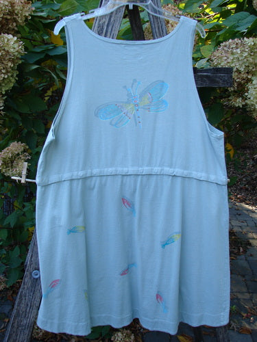 Barclay Little Tree Vest Dragonfly Fish Cucumber Size 1 hanging outdoors, featuring a dragonfly motif and pastel shapes. Sleeveless tunic style with unique empire waist and scooped hemline.