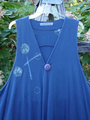 1996 State Fair Vest Directional Arrow Ridge Size 2: A sleeveless deep-blue jumper-style dress with a V-neck, oversized button, artistic leaf-and-circle prints, and wide A-line shape, showcasing vintage Blue Fish Clothing style.