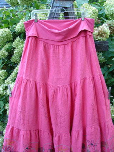 Barclay Linen Fold Over Three Tier Skirt Daisy Flamingo Size 2 hanging on a clothesline, showcasing its full cotton lycra waistline panel and triple horizontal tiers with a frayed lower hem.