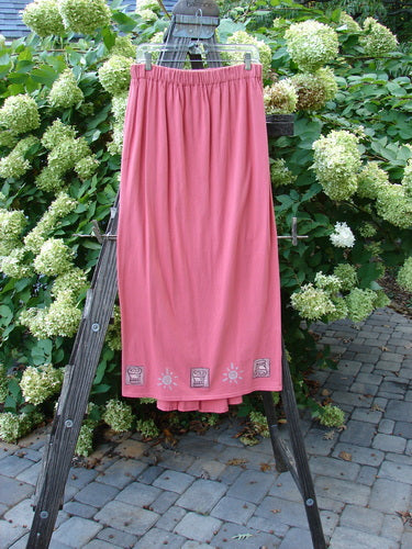 Image alt text: "1995 Kick Pleat Skirt in Papaya on a wooden ladder, showcasing a sassy rear kick pleat and a widening elongating shape. Perfect condition and made from organic cotton. From Bluefishfinder.com's Winter Resort Collection."