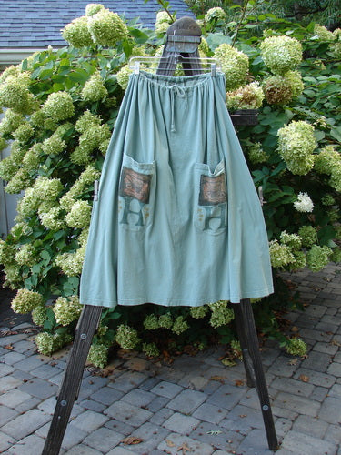 1994 Scoop Pocket Skirt Soup Aloe Size 2: A medium-weight cotton jersey skirt with a drawstring waist. Features two front scooped painted pockets and sectional panels. A lovely A-line shape with a big hem circumference for sway and flow. Vintage Blue Fish Clothing.