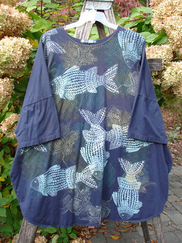 Barclay Short Sleeved Pop Top Mosaic Fish Ridge OSFA, displayed on a wooden easel, features a navy tunic with ¾ sleeves and pale-blue fish motifs, embodying Bluefishfinder.com's vintage creative expression.