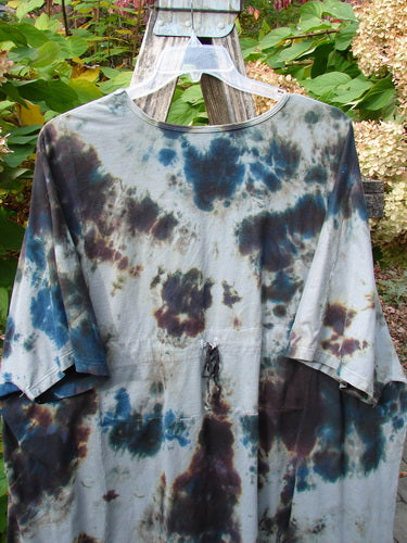 Barclay Drawcord Art Top Mottled Night Storm OSFA displayed on a hanger, showcasing its loose fit, A-line shape, wide sleeves, and drawcord detail against a natural outdoor backdrop.