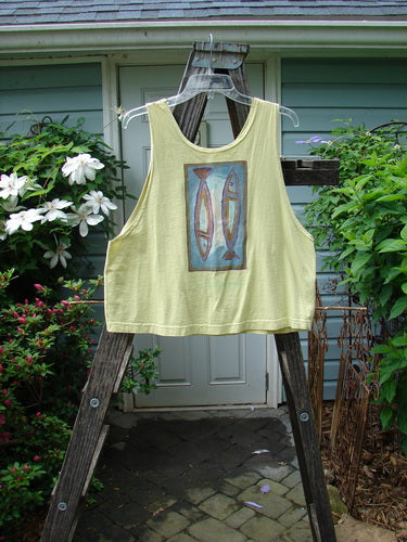 1999 Crop Tank Top Pike Duo Citron Size 0, shown on a hanger, featuring a scooped neckline and colorful double fish design. Mid-weight organic cotton, boxy shape, ideal for hot summer days.