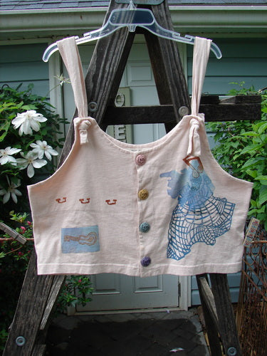 1996 Boxcar Vest Travel Music White Pine Size 1, displayed on a wooden ladder, features adjustable shoulder straps, multi-colored scribe buttons, and a bright blue signature patch, embodying Blue Fish's creative vintage style.