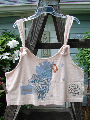 1996 Boxcar Vest Travel Music White Pine Size 1, displayed on a hanger, featuring blue designs, adjustable shoulder straps, and multicolored buttons, reflecting the whimsical style of Blue Fish Clothing.