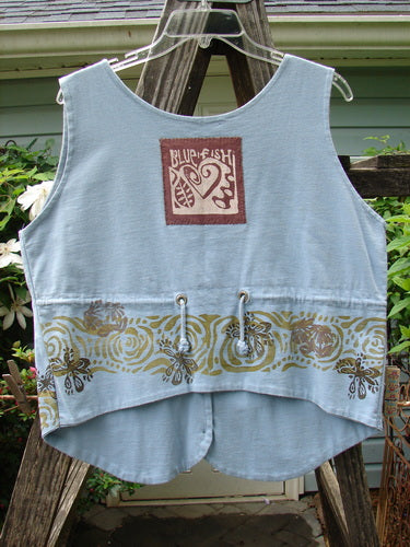Vintage 1993 The Vest Wind Garden Periwinkle Altered Size 1 with heart patch, tuxedo front, and drawcord back. Blue vest with unique details from BlueFishFinder.com, offering creative vintage fashion since 1986.