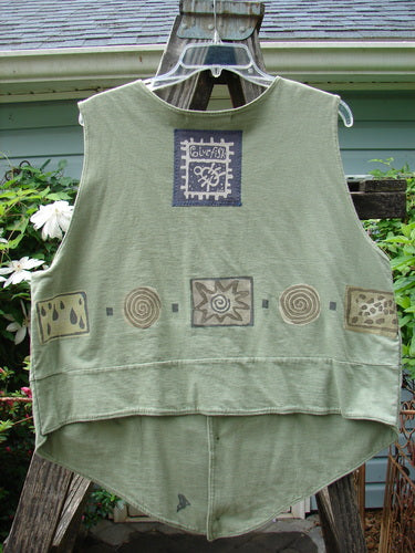 Vintage 1995 Button Vest with Wind and Rain Theme from BlueFishFinder.com. Green vest with patchwork design, tiny front buttons, loop closures, varying hemline, and Blue Fish patch. Unique and versatile piece.