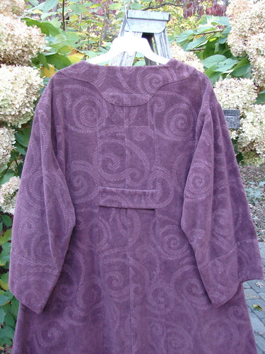 2000 Patched Upholstery Diwmach Coat Celtic Time Aubergine Size 2 displayed outdoors, showcasing its damask swirl pattern, colorful Celtic patches, scalloped neckline with vintage buttons, and belled sleeves.