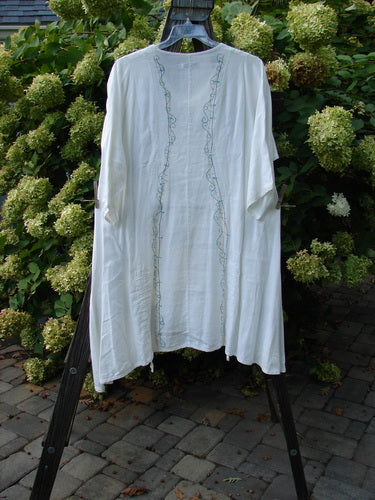 Barclay Linen Venetian Vented Tunic Dress String of Light White Size 1 displayed on a hanger, showcasing its soft V-neck, A-line shape, and double front drawcords.