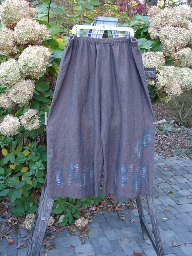 Barclay Cross Dye Linen Wide Leg Crop Pant Floral Sphere Wood Size 2: Brown, wide-leg, cropped trousers with elastic waist and visible patches, showcasing a rustic, artistic aesthetic typical of Blue Fish Clothing.