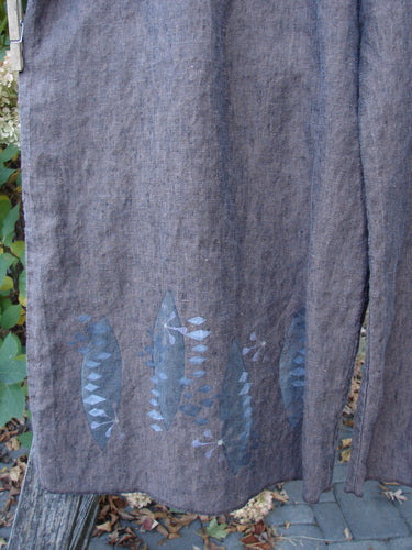 Barclay Cross Dye Linen Wide Leg Crop Pant with fish-shaped stencils along the hem, hanging outdoors. The pants feature a wide cropped length and larger elastic waistline, embodying Blue Fish Clothing's creative freedom ethos.
