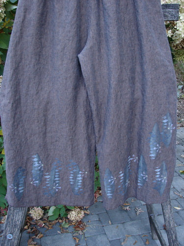 Barclay Cross Dye Linen Wide Leg Crop Pant Floral Sphere Wood Size 2 displayed outdoors, showcasing a lightweight linen fabric with blue botanical patterns along the hem, highlighting its wide-leg, cropped design.