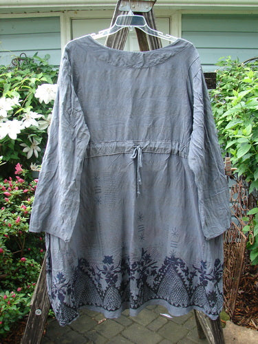 Barclay Linen Rayon High Low Tie Back Dress in Shadow Border Night Sky, Size 2, displayed on a clothes rack, highlighting its long sleeves and elegant design.