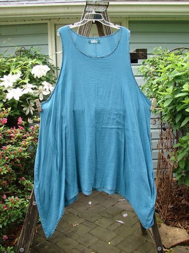 Barclay Crinkle Gauze Contrast Ditsy Daisy Pinafore in Unpainted Teal, Size 2, hanging neatly on a clothesline. The vintage-inspired piece features delicate floral patterns, embodying BlueFishFinder's unique style.