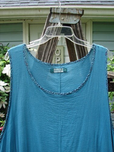 Barclay Crinkle Gauze Contrast Ditsy Daisy Pinafore in Unpainted Teal Size 2 displayed on a clothes hanger, showcasing its intricate pattern and airy texture.