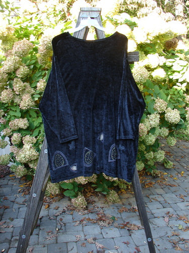 1996 Velvet Mythical Top, Ebony, Size 2: A black shirt on a wooden stand, with a primitive abstract design. Perfect condition, made from stretch velvet.