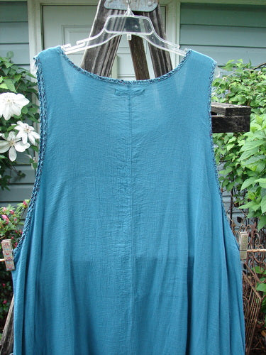 Barclay Crinkle Gauze Contrast Ditsy Daisy Pinafore Unpainted Teal Size 2 displayed on a clothes rack.