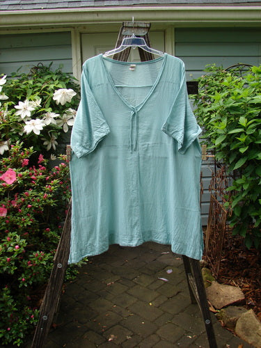 Barclay Batiste Deep Neck Tie Dress Unpainted Spearmint Size 2 hanging on a clothes rack.