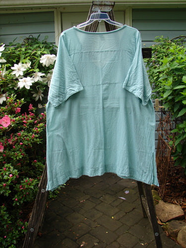 Barclay Batiste Deep Neck Tie Dress in Unpainted Spearmint, Size 2, displayed on a hanger against an outdoor background.