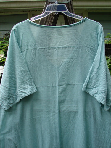 Barclay Batiste Deep Neck Tie Dress Unpainted Spearmint Size 2 on a clothes hanger, highlighting its short sleeves and casual, vintage-inspired design.