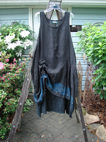 Barclay Linen Two Tier Venetian Eyelet Dress Pinwheel Black Size 2 displayed on a wooden rack, emphasizing the dress's elegant, vintage design.