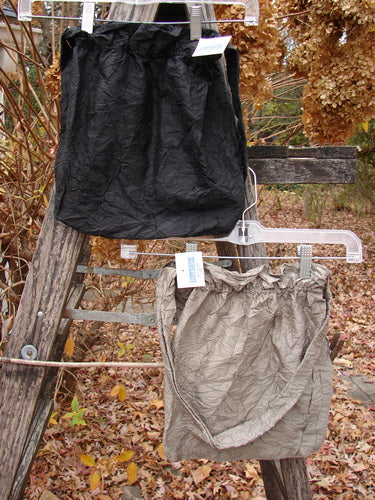 2000 NWT Shaunting Silk Bags Unpainted Black and Cement OSFA, showcasing elegant paper-bag–waist style skirts on a rustic ladder, embodying Bluefishfinder.com's vintage, expressive ethos. Ideal for both chic and casual ensembles.