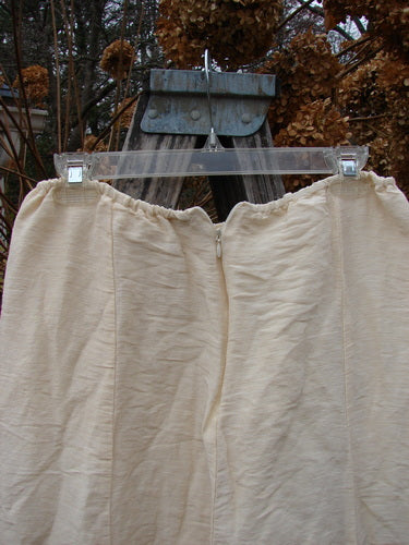 2000 Hemp Silk Reverse Skirt Unpainted Parchment Size 1 features an elastic waist and bubble hem. The cream-colored skirt hangs from a hanger, showcasing its textured, double-layered hemp silk fabric.