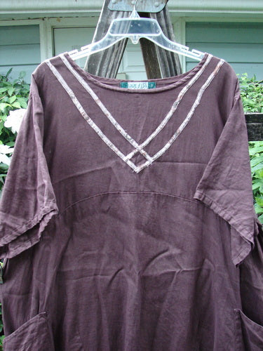 Barclay Linen Ditsy Cross Over Urchin Pocket Dress Burgundy Size 2 displayed on a hanger, showcasing its short sleeves and detailed design.