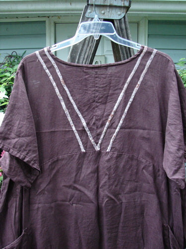 Barclay Linen Ditsy Cross Over Urchin Pocket Dress, Burgundy, Size 2, displayed on a hanger, showcasing its short sleeves and elegant design.