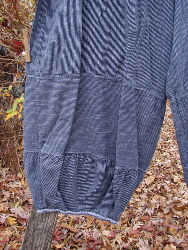 Barclay Hemp Cotton Meadow Pant in Unpainted Black Stripe Size 1, featuring tiered, gathered panels and a full elastic waist, suspended outdoors, highlighting its bellowing silhouette and pinstripe pattern.