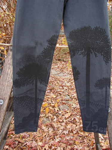 Barclay Cotton Lycra Straight Pant Shadow Tree Lux Silhouette Size 1 draped over a wooden rail, featuring a dark tree-silhouette pattern against fallen autumn leaves, illustrating BlueFishFinder's creative, vintage style.
