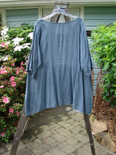 Barclay Linen Pinch Pocket Dress Shadow Sprig Storm Blue Size 2 on a clothes hanger, displayed on a clothes rack, showcasing its lightweight, three-quarter sleeved design.