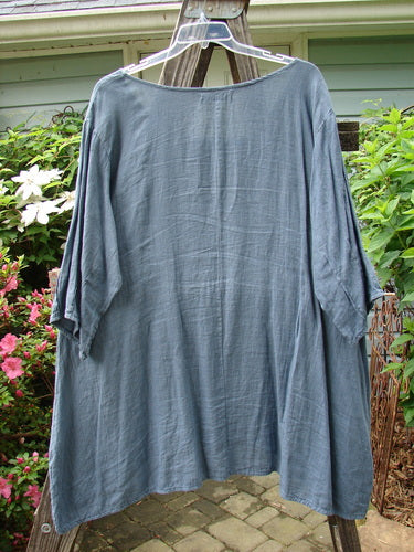 Barclay Linen Pinch Pocket Dress in Shadow Sprig Storm Blue, Size 2, displayed on a clothes rack. The dress features a lightweight, three-quarter sleeved design.