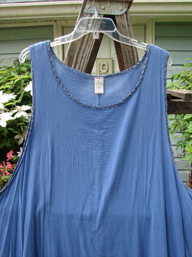 Barclay Crinkle Gauze Contrast Ditsy Daisy Pinafore in Unpainted Skylark, Size 2, displayed on an outdoor clothes hanger.