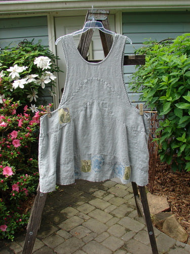 A vintage 1998 Botanicals Leafhopper Jumper apron featuring a single tulip design from BlueFishFinder. Heavy linen, unique pattern, scoop neckline, and painted details. Perfect for creative expression.