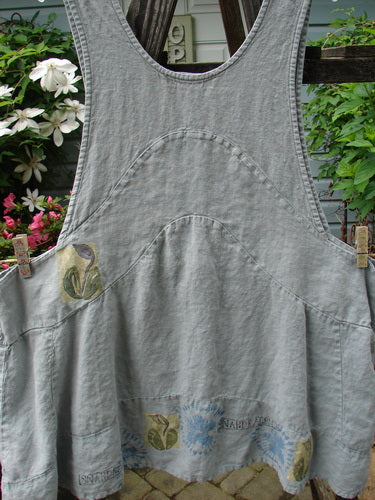 A vintage 1998 Botanicals Leafhopper Jumper apron from Birdsong in Perfect Condition Heavy Weight Linen. Features a unique single tulip theme paint design. OSFA sizing with double paneled waist and bib-style neckline.